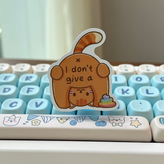 sticker of a cat with text of 'I don't give a shit' and rainbow poop