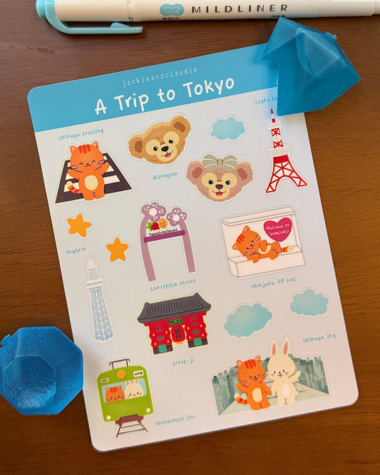 Sticker sheet titled 'A Trip to Tokyo' with cartoon characters and landmarks on a wooden surface.