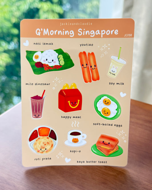 Card with illustrations of Singaporean food and drinks on a wooden surface.