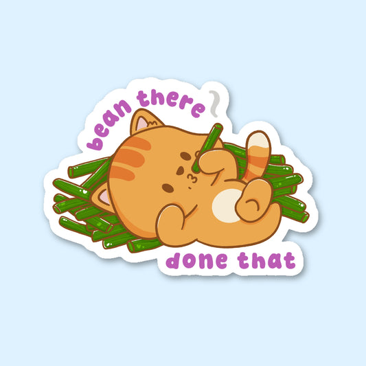 Sticker of a cat lying on beans with text 'bean there, done that'